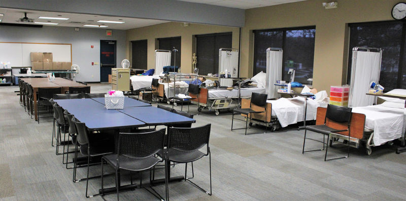 hospital beds with patient simulators on them, and a conference table and chairs in GCC 112, the temporary home for nursing