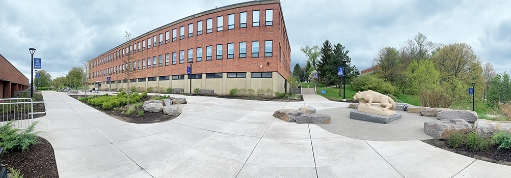 panorama photo of a patio outside of the brick Dawson Building 