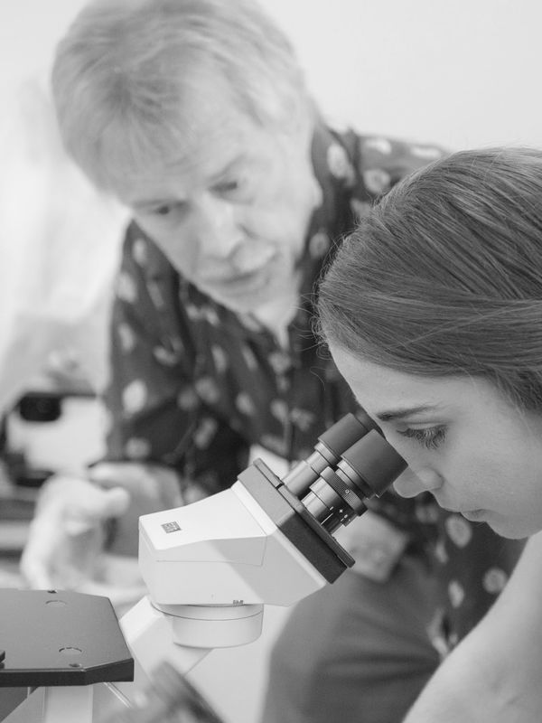 student looking on a microscope