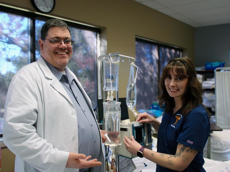 Mike Evans and Darla Lattimer pose for a photo in Penn State Scranton's nursing sim lab