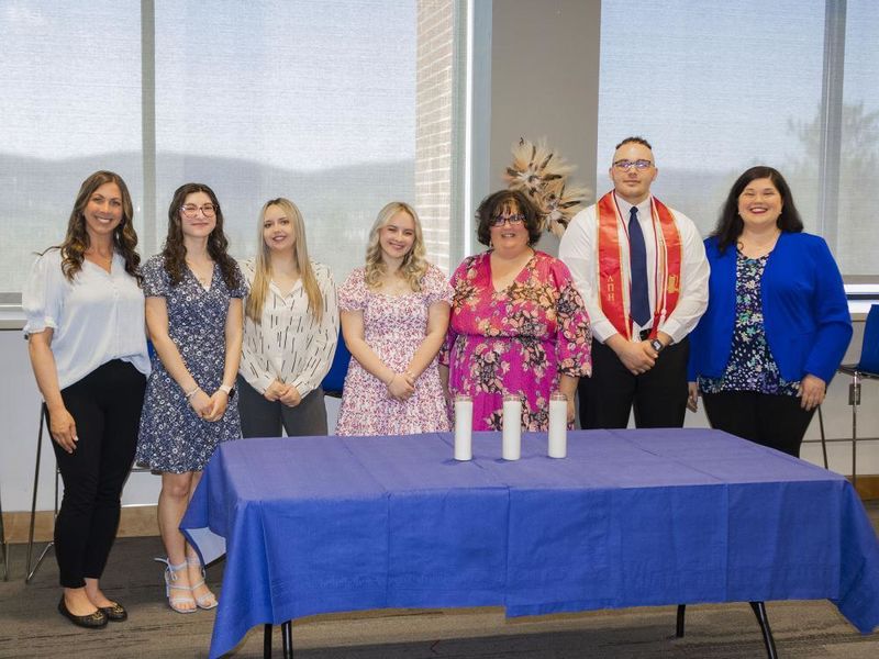group of honor society inductees pose for a picture at the induction ceremony