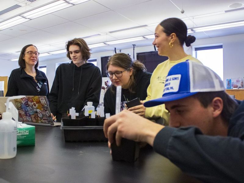 Professor Meg Van Etten and students work with plants in the campus' bio lab 