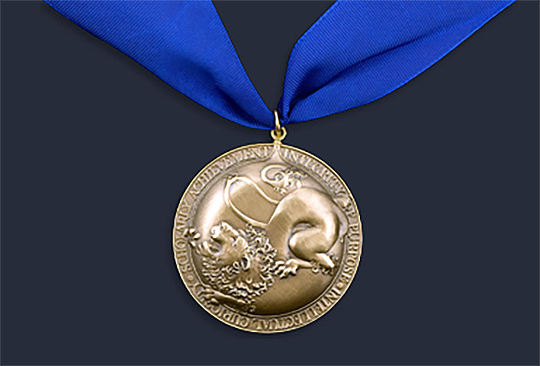 gold honors medal hanging from a blue ribbon