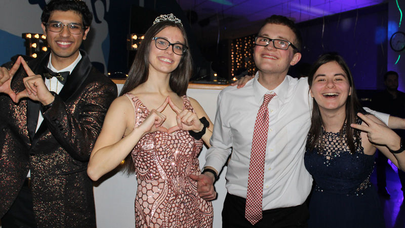 four students pose for photo at THON fundraiser