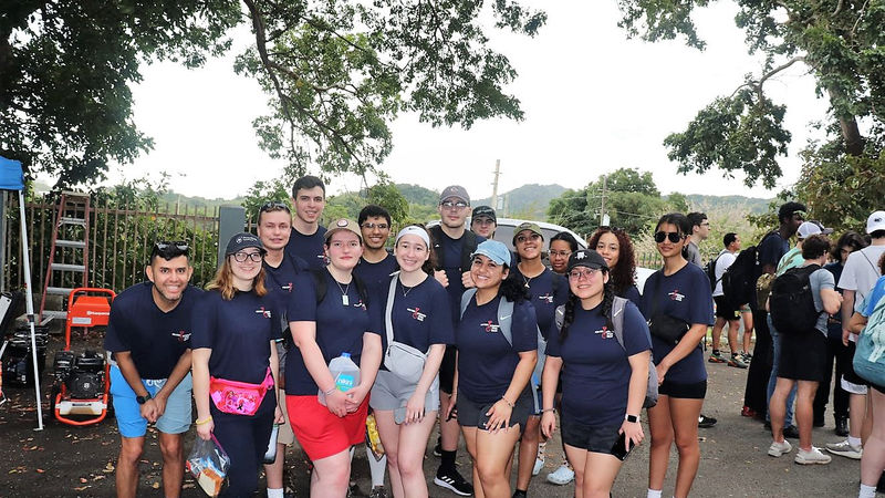 group of students in casual clothes pose for a photo at job site in Puerto Rico