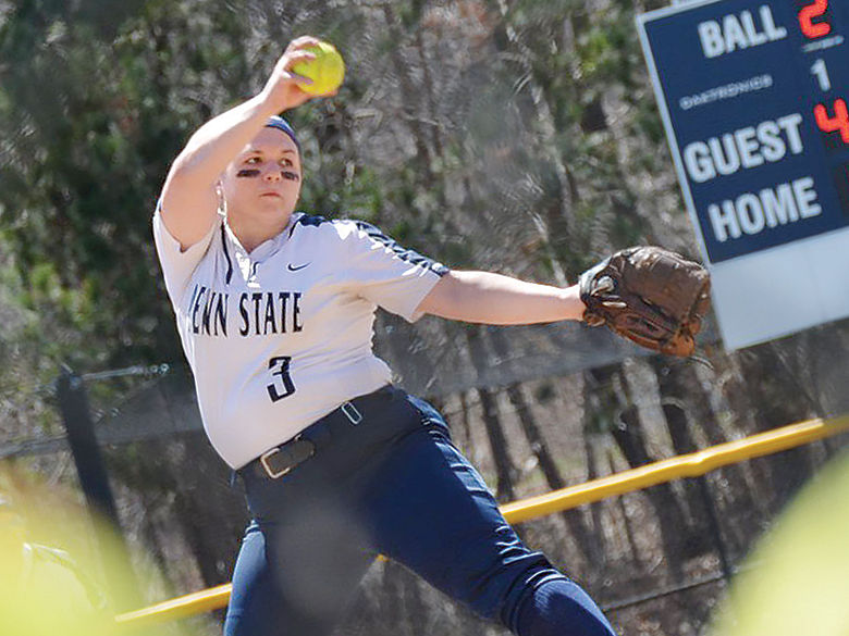 Penn State softball player winds up to pitch the ball