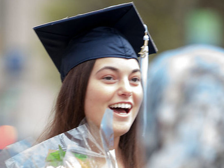 smiling graduate in cap and gowm