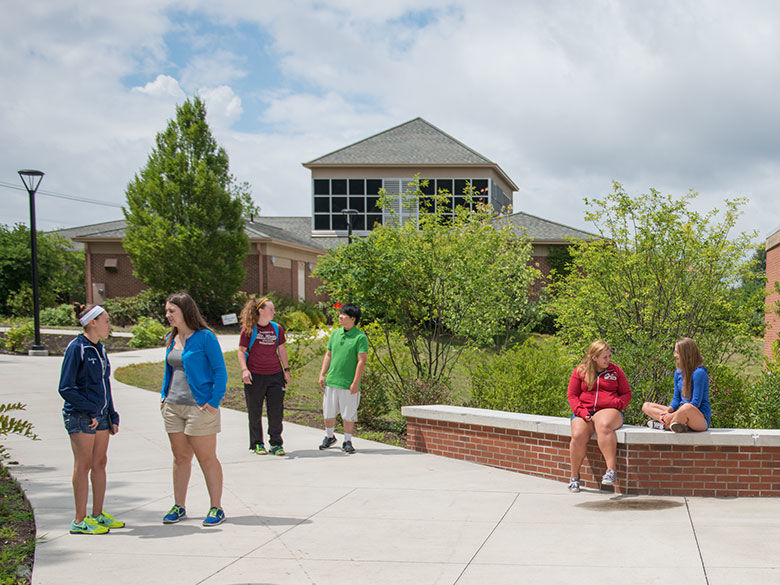 small group of students congregated on patio