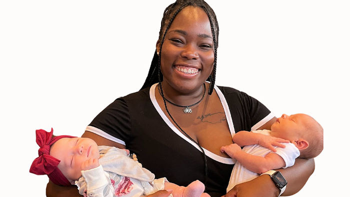 alumnae ashli daley holds two babies