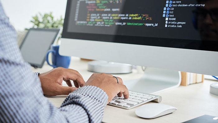 man works on computer develops software application