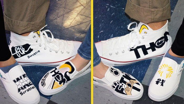 3 feet modeling white sneakers with THON artwork