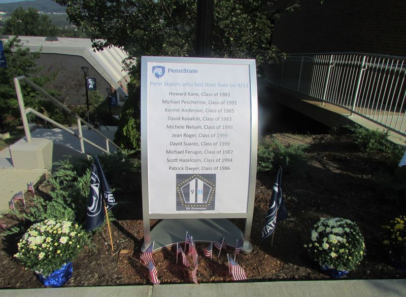 A sign listing the names of PSU alumni who died in the attacks