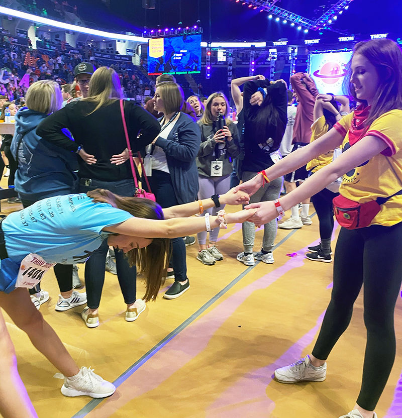 Dancer Lauren gets some help stretching out during THON