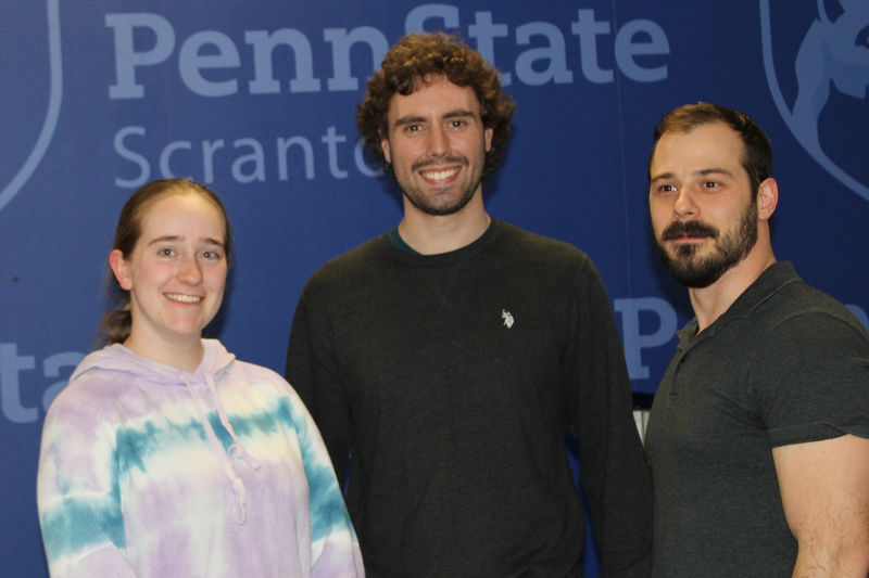 Three students accept their first place award in technology and engineering