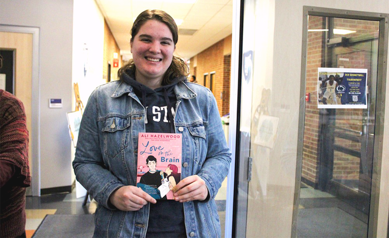 Student Chloe Tucker shows off her book, love on the brain.