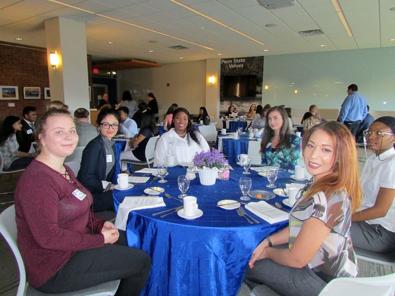 Students seated at table prior to start of etiquette dinner at pSWS