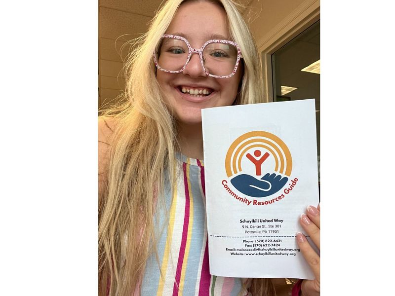 A student holds a brochure from the Schuylkill United Way