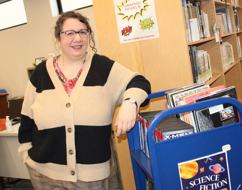 Reference and Instruction Librarian Kristin Green poses with the Penn State Scranton's roving Library Cart 