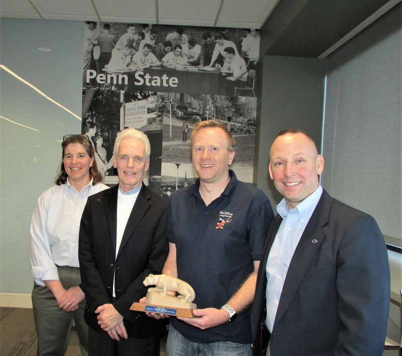 cesari holding Nittany Lion with faculty members