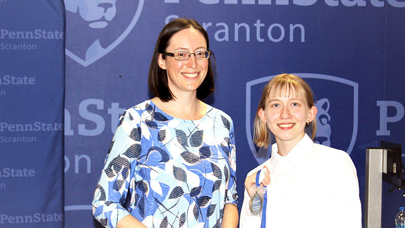 megan lucey receives her award from meg van etten