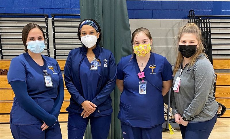 four nursing students pose for a photo at the Throop civic center vaccination clinic
