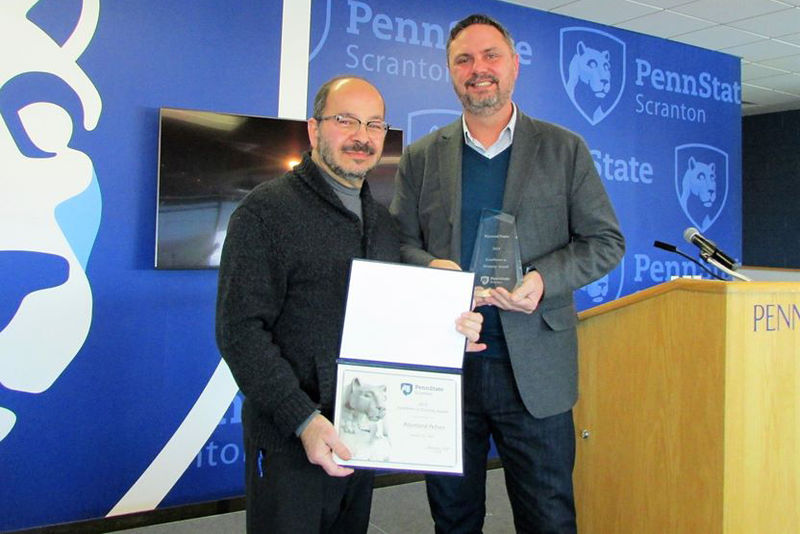 man presents certificate to a man