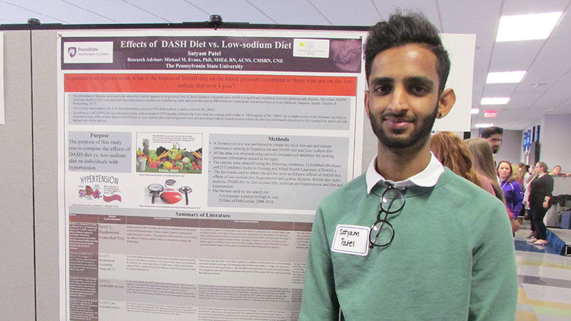 student with research poster