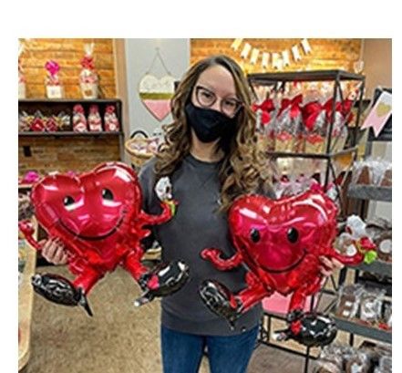 Jacqueline Reuther shows off some the Candy Kitchen's Valentine's Day decorations inside the store