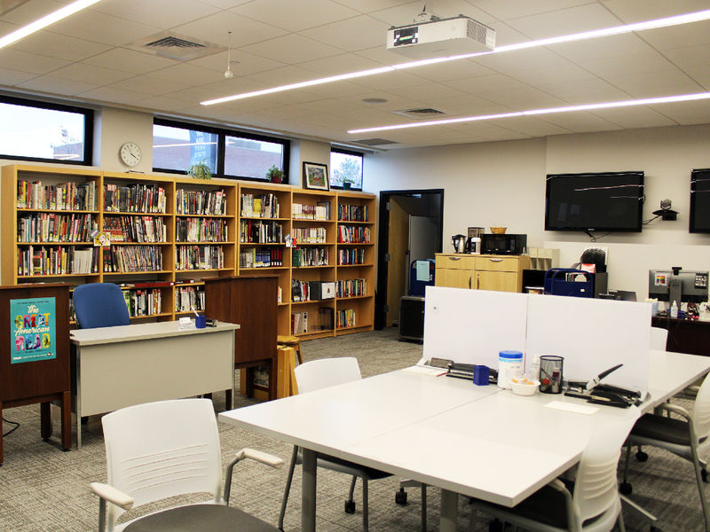 study tables and chairs, along with staff desks and bookshelves are set up in Dawson 10