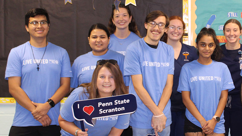 8 volunteers wearing united way day of caring shirts