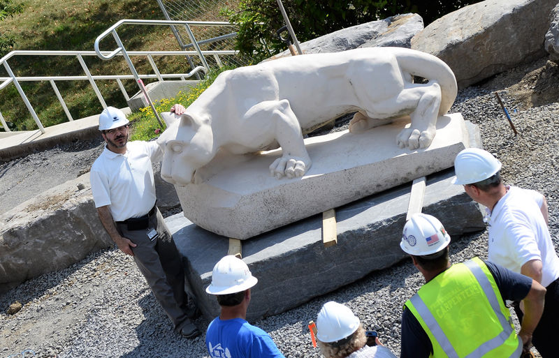 Dr. Wafa poses next to newly located lion