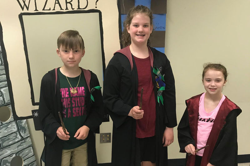 three young children wear capes at Wizard camp
