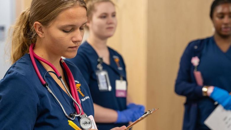 Nursing students in patient simulator lab