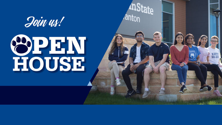 group of smiling students siting in front of penn state scranton sign