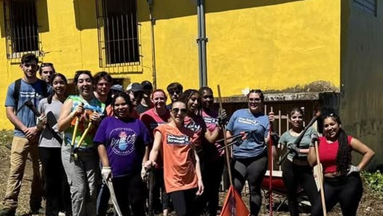 ASB group of students pose outside one of the buildings they volunteered in