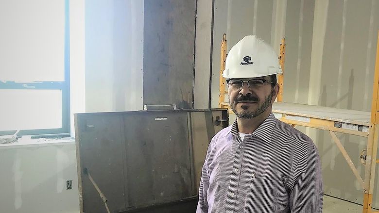 Dr. Marwan Wafa standing in his gutted office