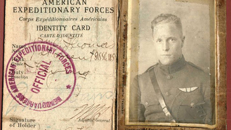 old black and white image of a man in uniform and an old document
