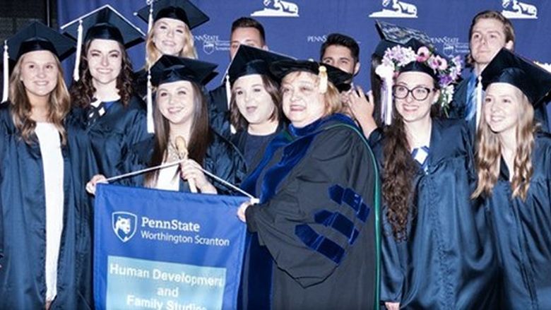 HDFS alumni posing for photo with Dr. Melnick, HDFS program cocordinator
