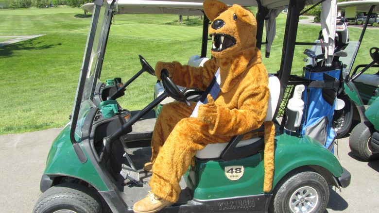 Nittany Lion driving golf cart at last year's tournament
