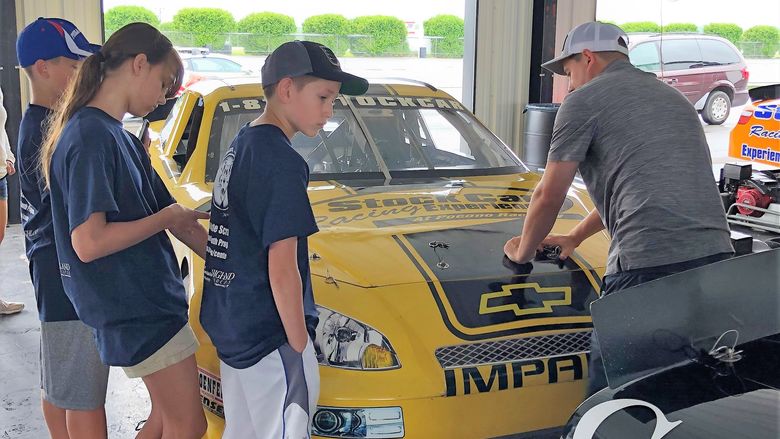 Race car campers looking at race car at Pocono Raceway