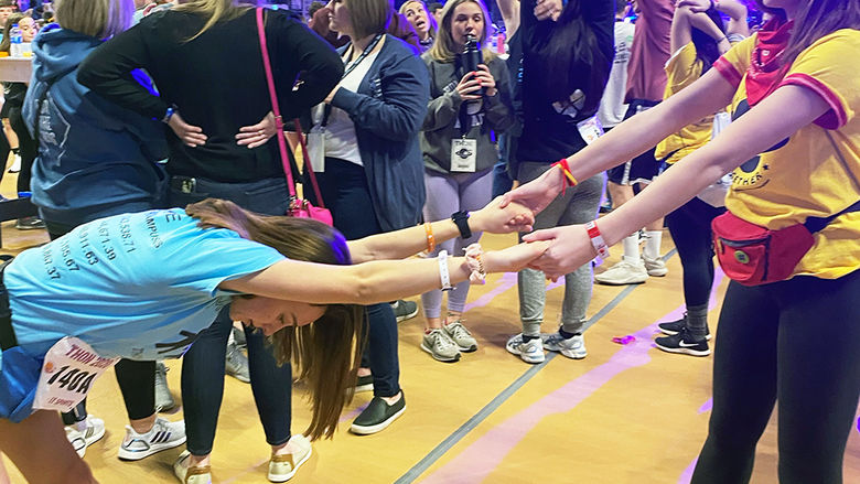 Dancer Lauren gets some help stretching out during THON