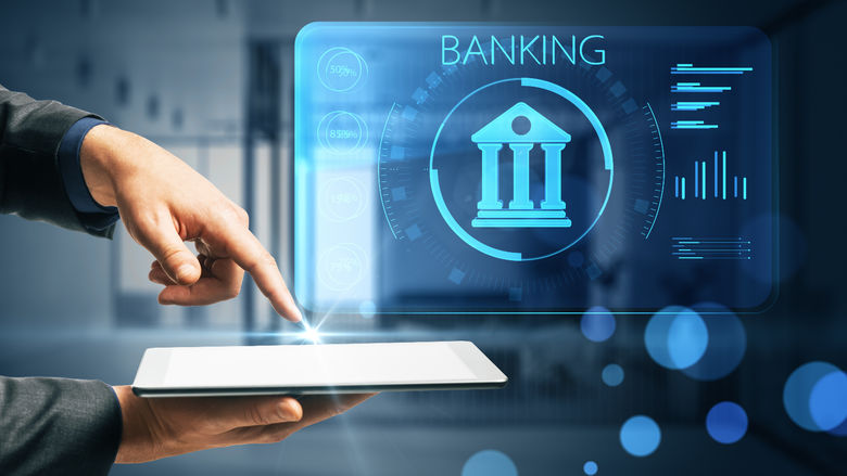 Human hand above electronic tablet points to AI banking application, which the word "Banking" appears in blue at the right.