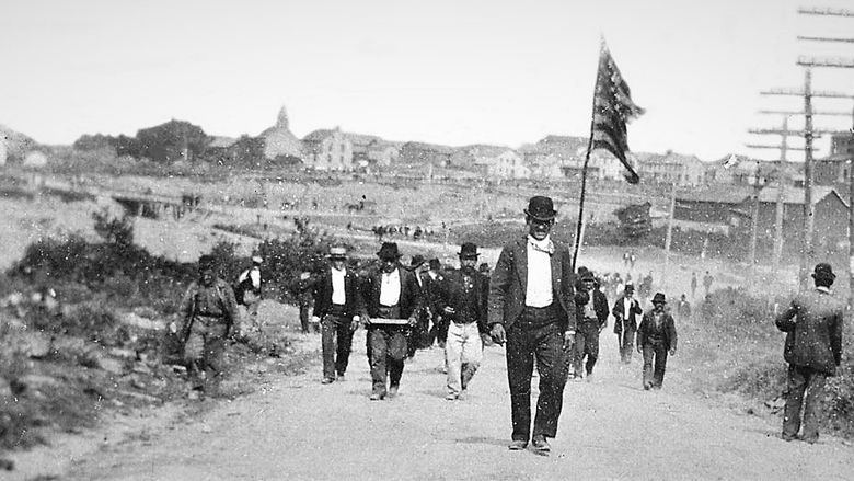Historic photo of anthracite miners walking down street