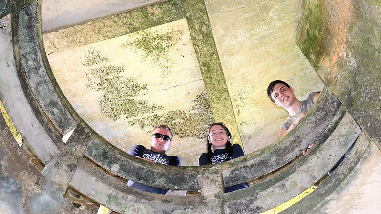 students look down from a bell tower they toured