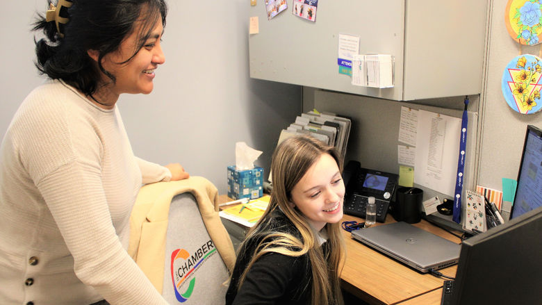 Penn state scranton intern Taylor Burdick on the job at the chamber shown collaborating at her computer with her supervisor