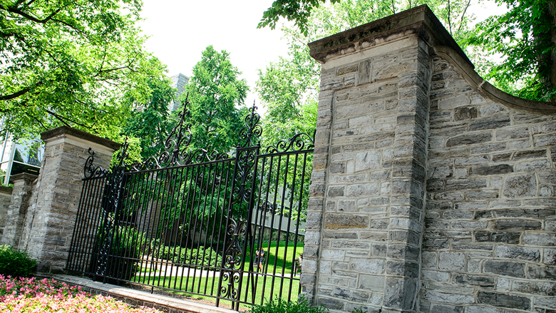 Photograph of the gates to campus from Allen Street