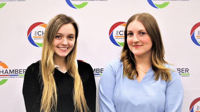 Chamber interns Burdick and Miller posed for photo in front of Scranton Chamber wall