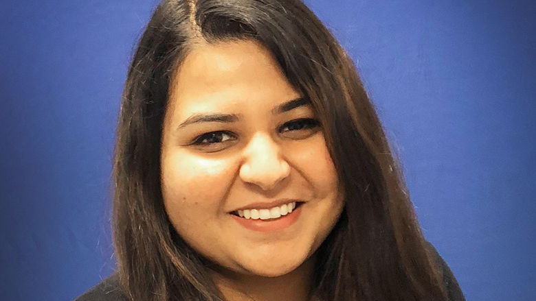 headshot of dharti ray with blue background