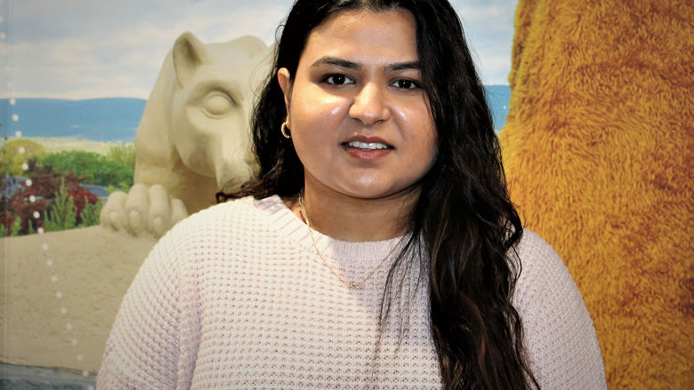 Photo of Dharti Ray in front of the Lion Shrine