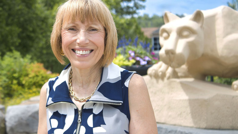 Dr. Darlne Dunay poses for a photo by the scranton campus' Nittany Lion Shrine